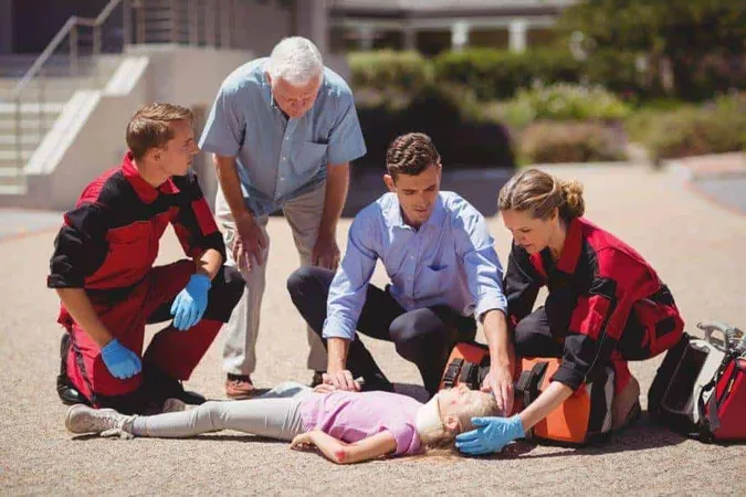 Paramedics Examining Injured Girl X - Emergency Medical Technician study guide