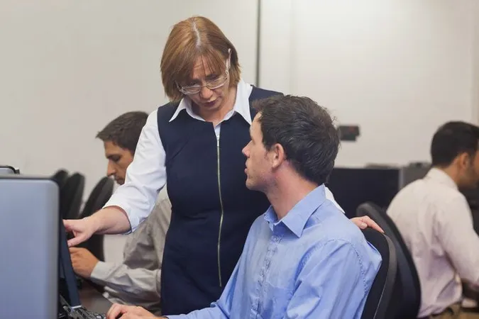 Mature Female Teacher Talking Student - Education Support Professional Certified study guide