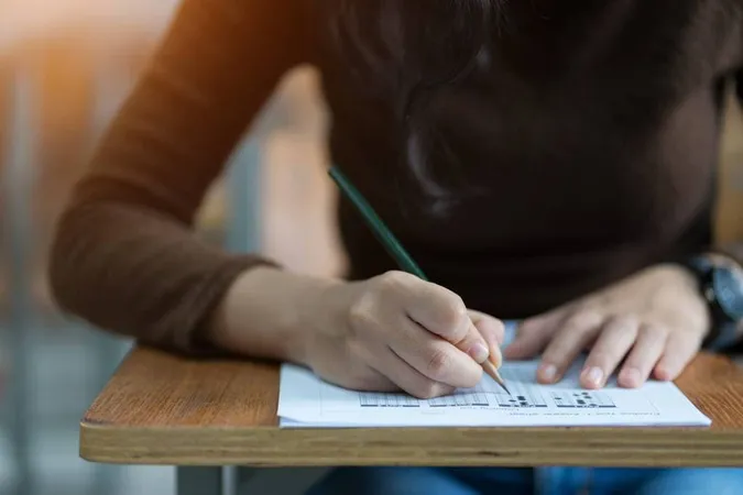 Midsection Student Writing Exam Desk Classroom - Educational Testing Service study guide