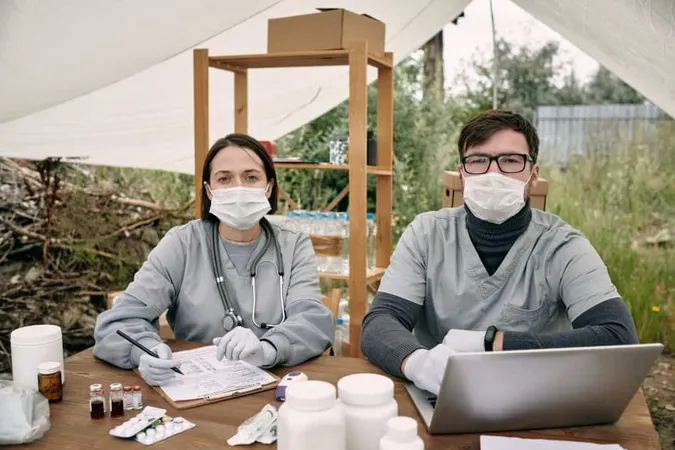 Two Gloved Clinician Uniform Working By Table X - Fellowship of the Australian College of Rural and Remote Medicine study guide