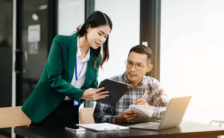 Asian Business Colleague Business Presents Explains Using Laptop Tablet Teamwork Financial Marketing Team While Sitting Modern Office X - Financial Adviser Standards and Ethics Authority study guide
