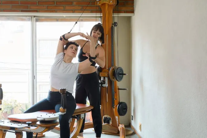 Two Adult Women Training Together With Gyrotonic Machine Home 1 1 X - Gyrotonic Certification study guide
