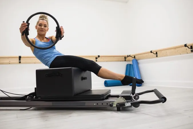 Woman Exercising With Pilates Ring X - Gyrotonic Certification study guide