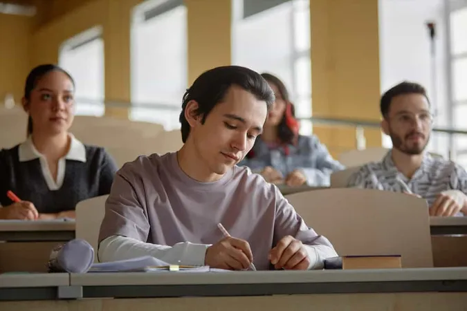 Male Student Writing Lecture Cla - GED study guide