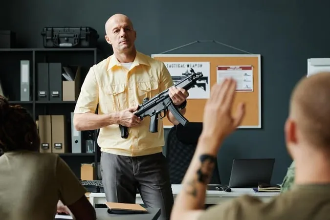 Serious Male Coach Military Training With Machine Gun Hands - Gun Safety Instructor study guide