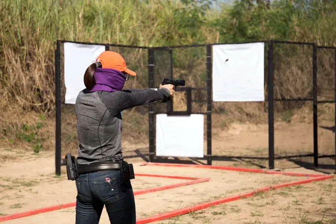 Woman Aiming Pistol Shooting Range X - Handgun Instructor Certification study guide