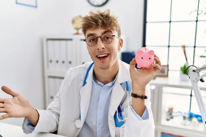 Young Caucasian Doctor Man Wearing Doctor Uniform Holding Piggy Bank Clinic Celebrating Achievement With Happy Smile Winner Expression With Raised Hand X - Health Savings Account Certification study guide