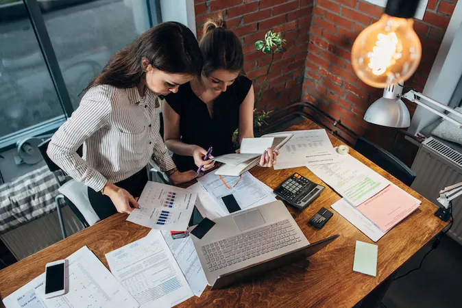 Top View Concentrated Young Women Sitting Table Working Together - International Association of Bookkeepers Certification study guide
