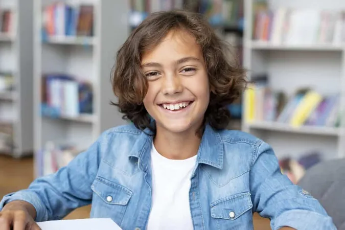 Boy Smiling While Sitting Library X - Middle Years Literacy and Numeracy Selective Entry Test study guide