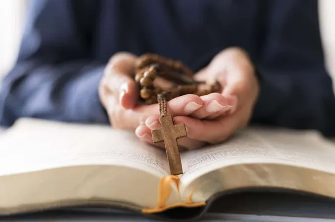 Person Holding Rosary With Cross Open Holy Book X - National Association of Catholic Chaplains study guide