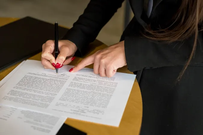 Brunette Businesswoman Writing D - Notary study guide