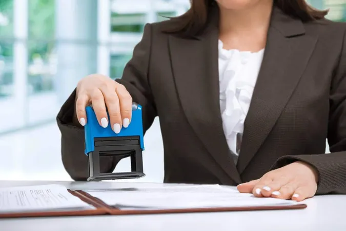 Businesswoman Putting Stamp Docu - Notary study guide