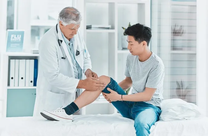 Man Doctor Patient With Knee Injury Physiotherapy Checkup Muscle Exam Clinic Male Person Therapist Physio With Client Leg Pain Ache Sprain From Accident Hospital X - Orthopedic Certified Specialist study guide