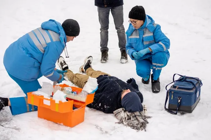 Group Young Paramedics Winter Uniform Squatting Helping Sick Unconscious Man Lying Snow X - Outdoor Emergency Care Certification study guide