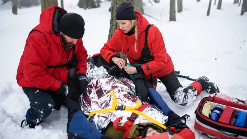 Paramedics From Mountain Rescue Service Provide Operation Outdoors Winter Forest Injured Person Stretcher X - Outdoor Emergency Care Certification study guide