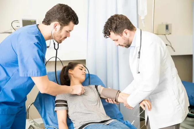 Two Male Doctors Checking Heart Beats Blood Pressure Female Patient Emergency Room X - Pediatric Emergency Assessment, Recognition, and Stabilization study guide