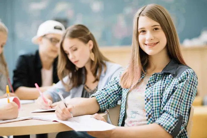 Smiling Girl Posing With Classmates 1 X - Preliminary English Test study guide