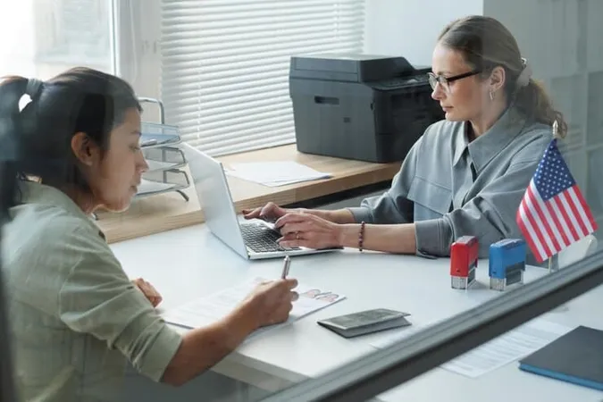 Through Glass Wall Shot Modern Hispanic Woman Having Appointment Us Embassy Signing Papers Whi - Certified Qualified Domestic Relations Order Specialist study guide