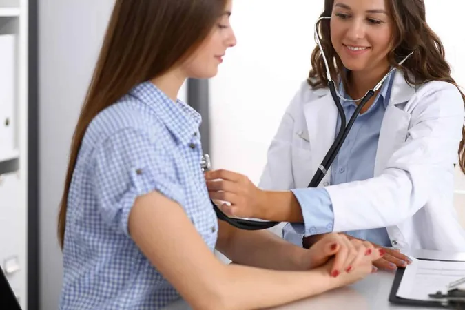 Doctor With Stethoscope Hand Examining Her Female Patient Health Care Cardiology Medicine Concepts 1 X - Relias Certification study guide