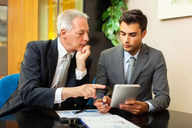 Two Businessmen Discussing Financial Charts X - Registered Investment Advisor study guide