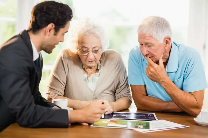 Businessman Showing Sheets Senior Couple Home X - Retirement Management Adviser Certification study guide