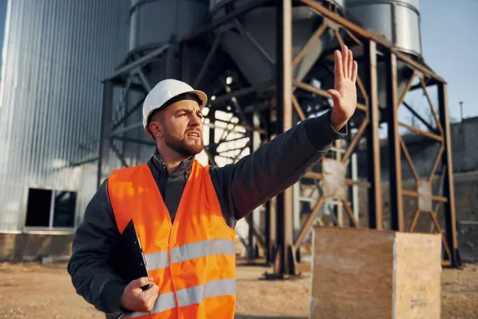 Showing Stop Gesture Construction Worker Uniform Is Outdoors Near Factory X - Rigger and Signal Person Certification study guide