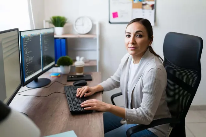 Beautiful Latin Woman Making Eye Contact While Typing Computer Writing Code Professional Woman Working As Programmer Freelancer X - Selenium Testing Certification study guide