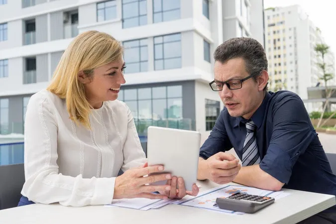Smiling Woman Showing Male Colleague Tablet Screen Cafe Outdoors - Society of Trust and Estate Practitioners Certification study guide