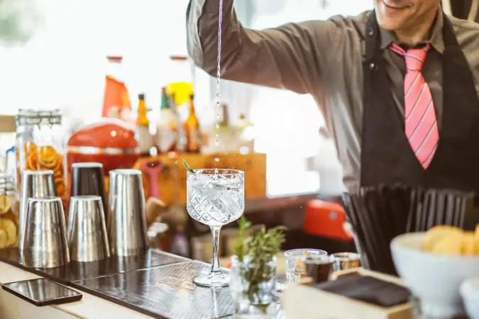 Midsection Waiter Preparing Drink Table Restaurant X - Maryland Techniques of Alcohol Management Certification study guide