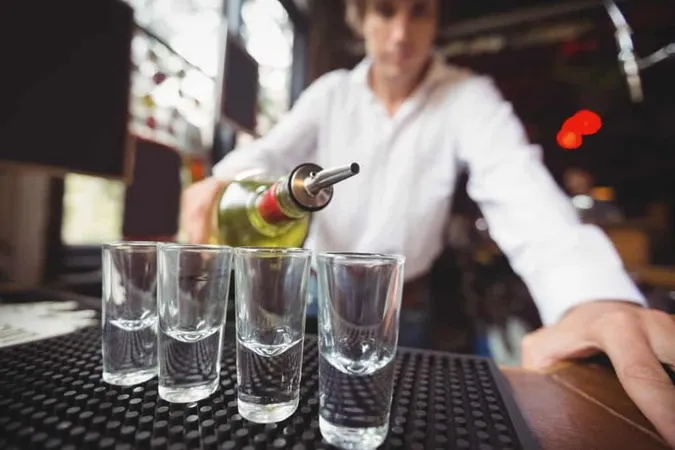 Close Up Bartender Pouring Tequila Shot Glasses X - Training for Intervention Procedures Certified study guide