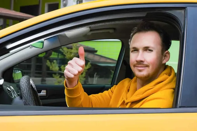 Young Happy Male Taxi Driver Sits Wheel Taxi Shows Like X - Taxi and Limousine Commission study guide