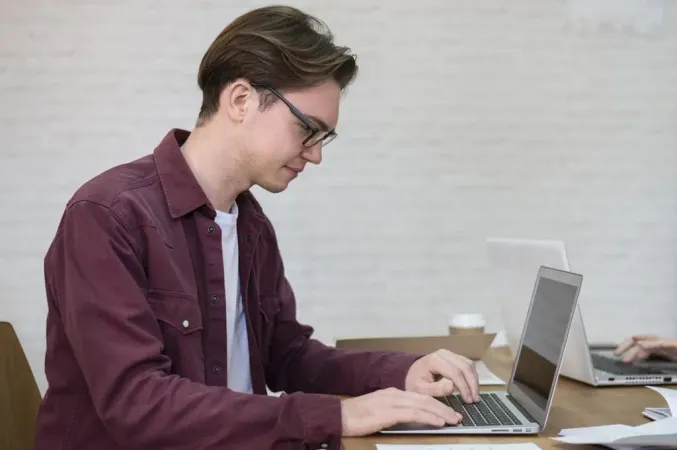 Side View Boy Using Laptop Group - TOEFL study guide