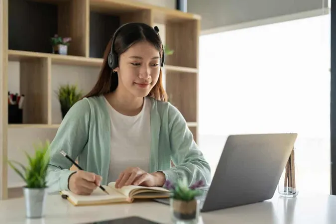Young Woman Using Laptop Table 1 - TOEFL study guide