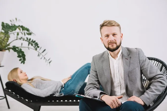 Confident Male Psychologist Sitting Chair Front Her Female Patient X - Trauma Treatment Certification study guide