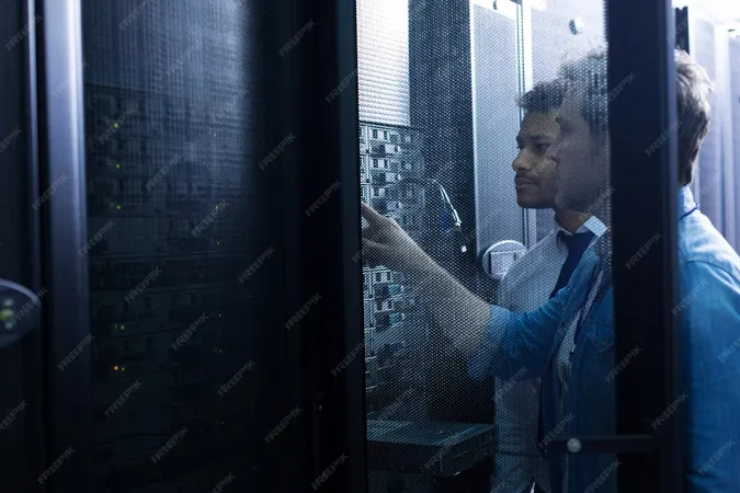 Handsome Serious Male Technician Standing Near His Colleague Looking Network Server While Pressing Button - VCA-DCV VMware Certified Associate on vSphere study guide