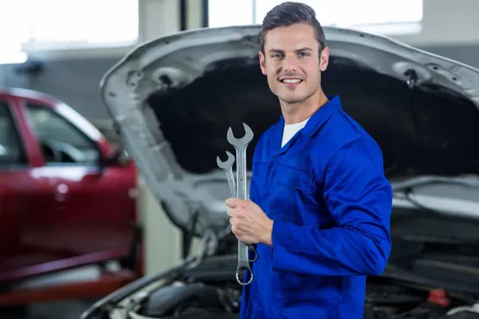 Mechanic Holding Wrench X - Volkswagen Certified Mechanic study guide